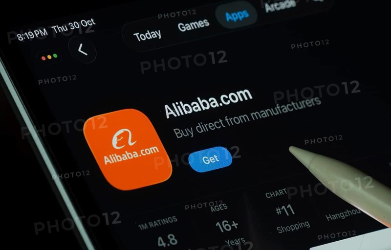 Dhaka, Bangladesh- 21 Nov 2025: Alibaba.com app displayed on a iPad screen in dark mode with a digital pen pointing at it
