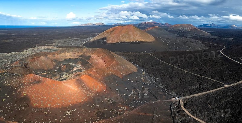 Montaña Quemada and Montaña Pedro Perico volcanoes, volcanic landscape with craters and lava fields, aerial view, Lanzarote, Canary Islands, Spain