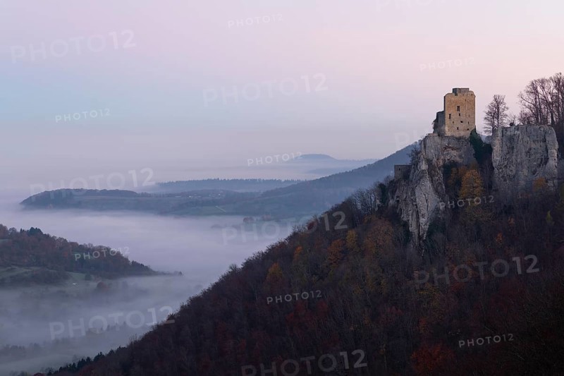 Sunrise with fog in the Neidlinger Valley with a view of the Reussenstein castle ruins. Swabian Jura, Baden-Württemberg, Germany