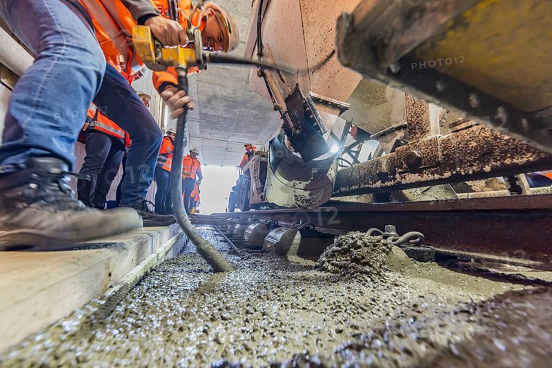 Deutsche Bahn AG track construction at Stuttgart Airport. The last few meters of solid road in the airport tunnel are concreted. This means that all long-distance railway tracks of Project S21 have been laid. Workers lay the rails and concrete the track bed. Stuttgart, Baden-Württemberg, Germany