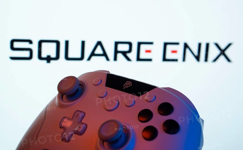 Dhaka, Bangladesh- 14 Nov 2025: A close-up of a gamepad with the Square Enix seen on screen in the background