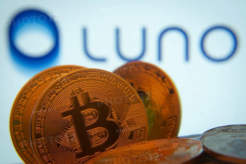Dhaka, Bangladesh- 03 Sep 2025: Close-up of Bitcoin coins with the Luno logo visible on a screen in the background