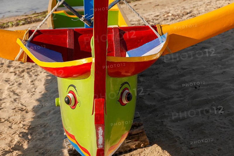 Colourfully painted outrigger fishing boats, (Junkung), on Sanur beach, Bali, Indonesia