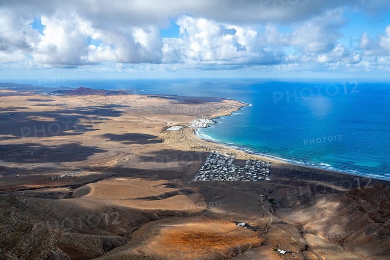 View from the Risco de Famara cliffs to the coast and the sea with the Famara beach, Playa de Famara, Lanzarote, Canary Islands, Spain