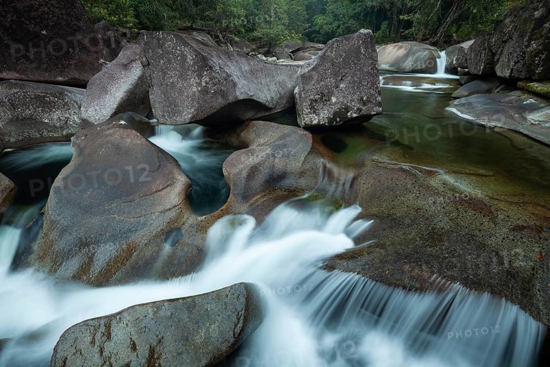 Turquoise blue water between rocks in the tropical rainforest of Babinda Boulders Queensland Australia