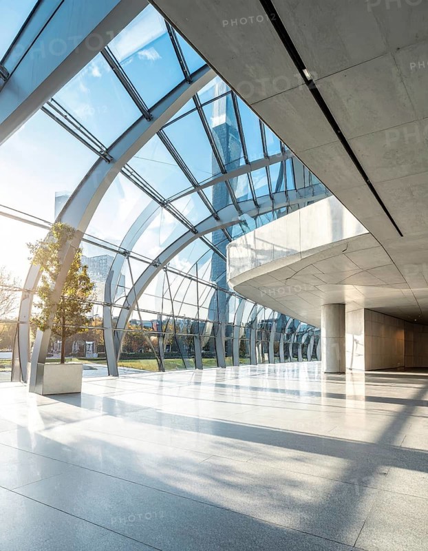 Modern architectural framework with glass and steel structure, glass facade with a greed of steel arrows, blue sky with a soft golden light of a sunrise, AI generated