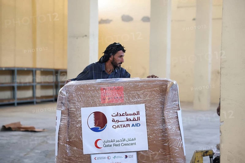 Relief workers unload boxes of medical aid provided by Qatar at Damascus International Airport, part of the humanitarian bridge supporting Syria's recovery and reconstruction after the fall of Bashar al-Assad, Damascus, Damascus, Syria