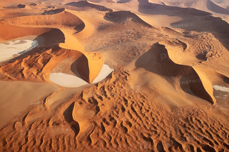 Sand dunes and dry pans in the Namib Desert. In the evening. Aerial view. Namib-Naukluft Park, Namibia
