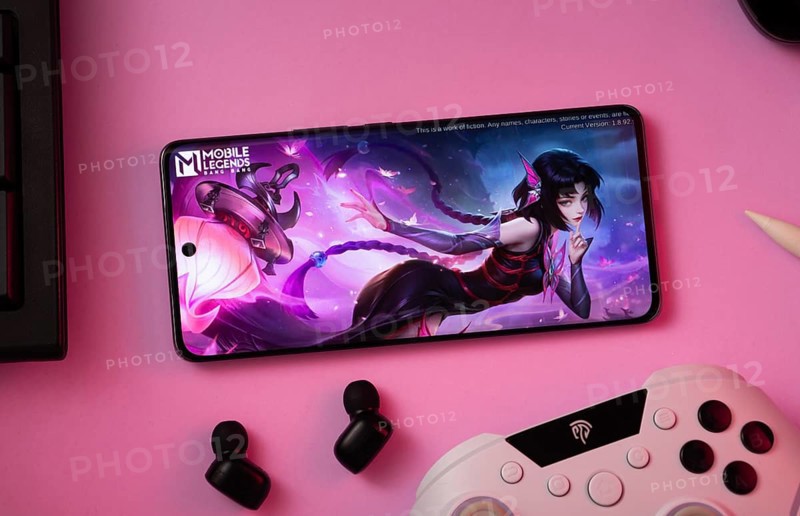 Dhaka, Bangladesh- 25 Aug 2025: A close-up of a gamepad with the Mobile Legends Bang Bang seen on smartphone