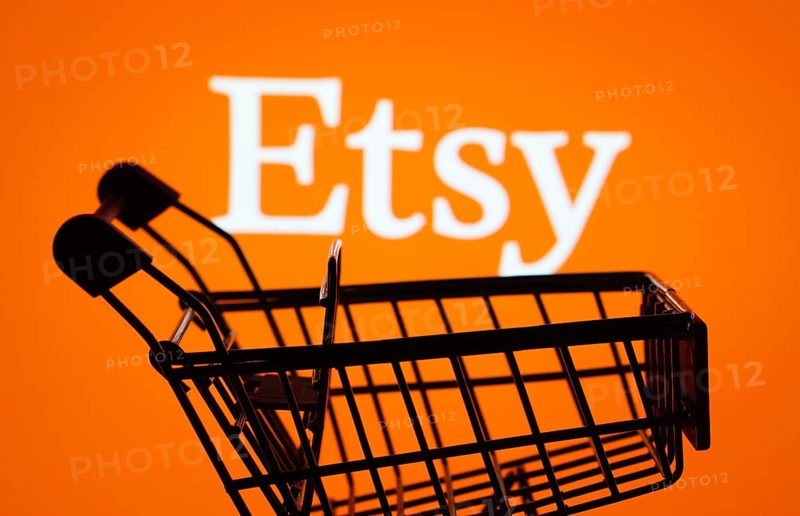 Dhaka, Bangladesh- 03 July 2025: Silhouette of a shopping cart in front of the Etsy logo, symbolizing ecommerce and online shopping