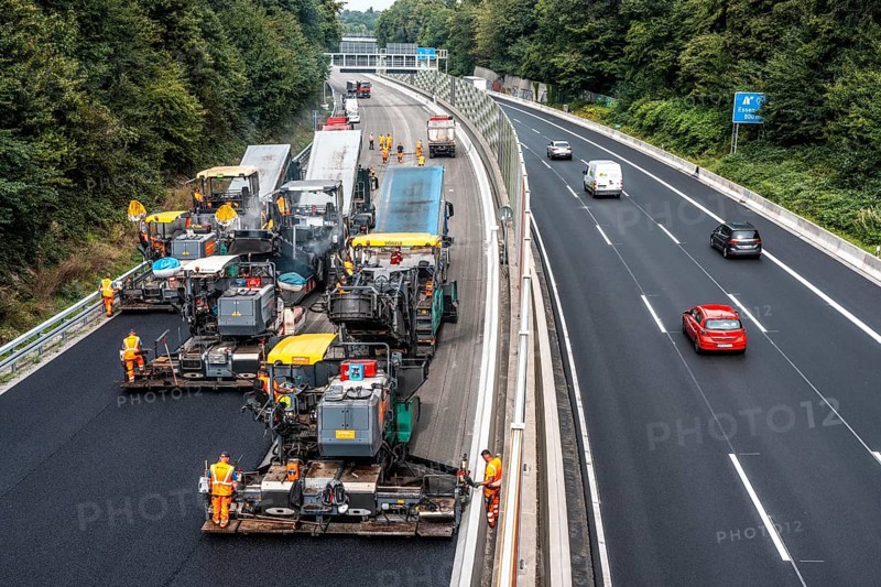 Rehabilitation of the A52 motorway near Essen, an 8 km long section between the Essen-Kettwig junction and the Essen-Ost motorway junction was completely renovated over a period of 9 years, 6 lanes, new drainage pipes, carriageway, bridges, noise barriers, traffic facilities, here the last section, direction Düsseldorf, new carriageway surface, laying of porous asphalt, whispering asphalt, at the Essen-Rüttenscheid junction, North Rhine-Westphalia, Germany