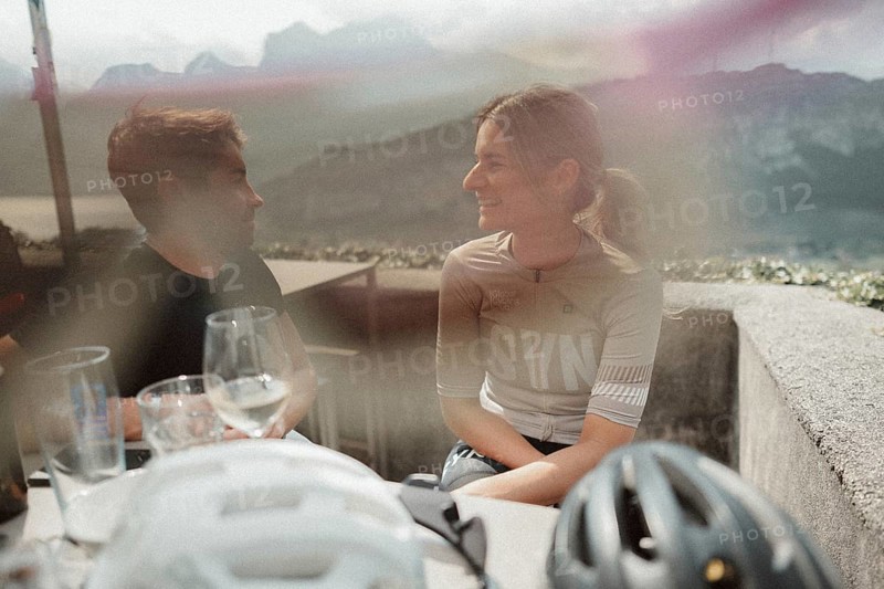 Young man taking a coffee break while riding his racing bike on Lake Garda. Sunny weather and dolce vita