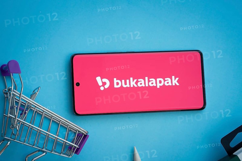 Dhaka, Bangladesh- 03 July 2025: Smartphone displaying Bukalapak logo with shopping cart on a blue background