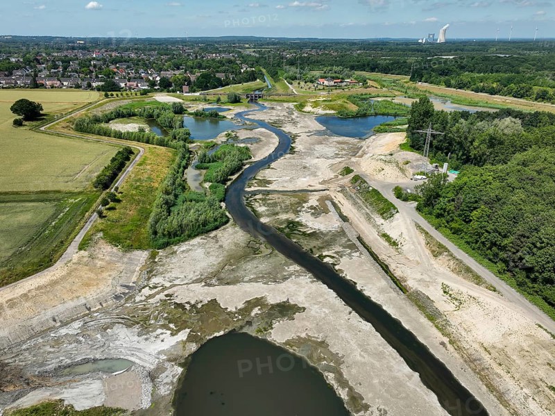 Dortmund, Castrop-Rauxel, North Rhine-Westphalia, Germany - River renaturalisation, renaturation of the Emscher, flood retention basin HRB Mengede. A new floodplain landscape is being created at the Emscher-Auen farm, expanding the area for flood protection during heavy rainfall and for biodiversity. The previously straightened Emscher is being given curves again and can meander through its new floodplain. Following the construction of a parallel sewer, the Emscher has been completely free of sewage since 2022. The river was previously an open, above-ground mixed water channel with rainwater and wastewater. At the back right, the Uniper coal-fired power plant Datteln 4 power station