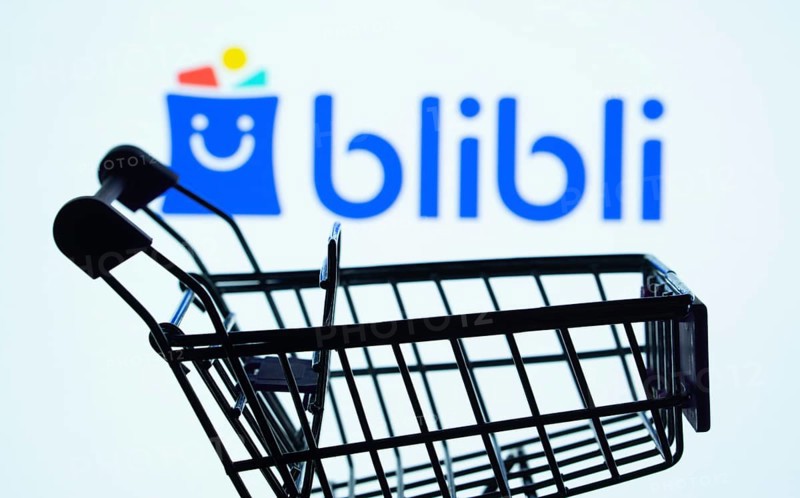 Dhaka, Bangladesh- 03 July 2025: Silhouette of a shopping cart in front of the Blibli logo, symbolizing ecommerce and online shopping