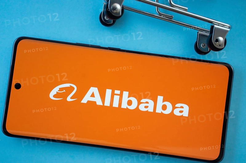 Dhaka, Bangladesh- 03 July 2025: Smartphone screen showing the Alibaba logo with shopping cart wheels on a blue background