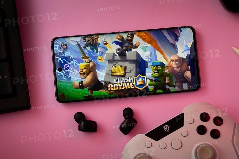 Dhaka, Bangladesh- 15 July 2025: A close-up of a gamepad with the Clash Royale seen on smartphone
