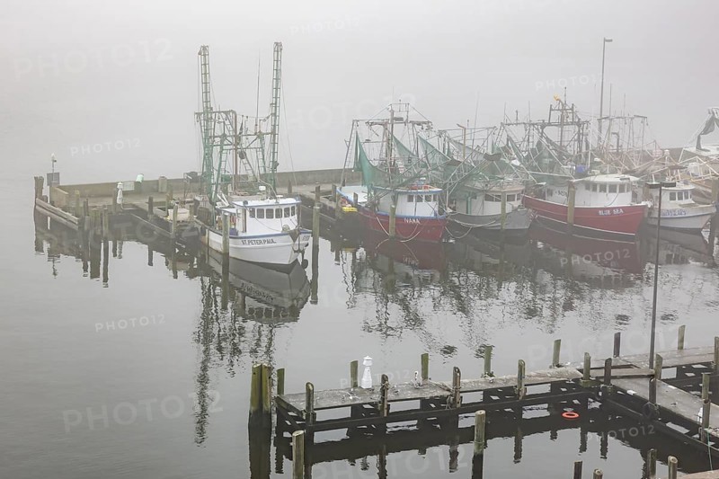 Commercial shrimp boats at the dock in the commercial area of the Biloxi Small Craft Harbor in Biloxi, Mississippi
