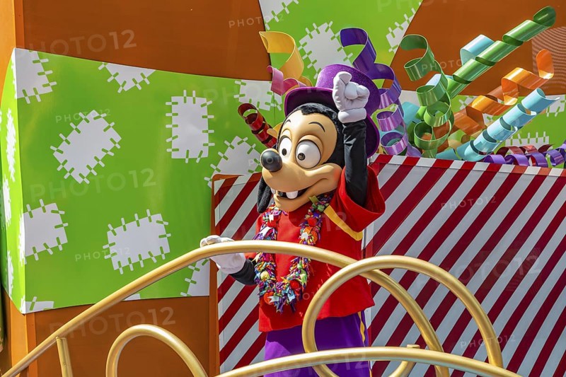 Disney character riding on float during parade through the Frontierland area of Magic Kingdom at Walt Disney World, Orlando, Florida