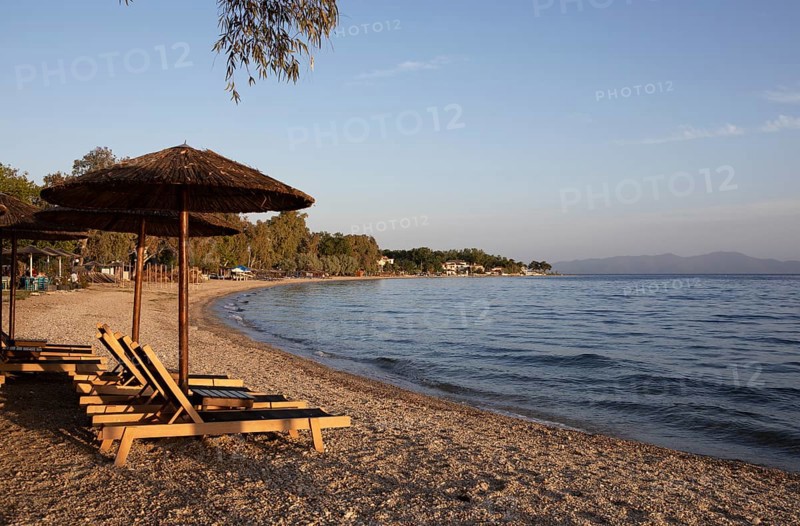 Sun loungers on the beach of Kala Nera at sunset on the Pagasitic Gulf, Pelion or Pelion Peninsula, Magnisia, Thessaly, Greece