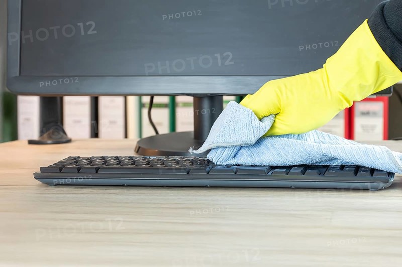 Office cleaning: Close-up of the cleaning of an office desk