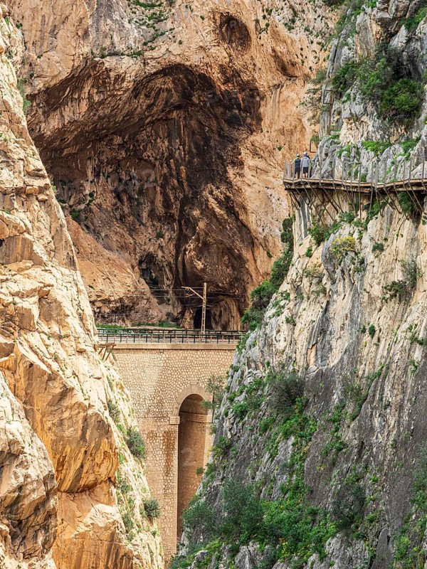 Tourists on the elevated path of the caminito del rey, along a deep gorge, Andalusia, Spain