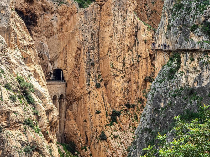 Tourists on the elevated path of the caminito del rey, along a deep gorge, Andalusia, Spain