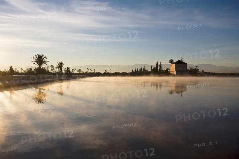 The Menara gardens, basin and minzah, a palace-like pavilion, High Atlas mountains behind, Morocco