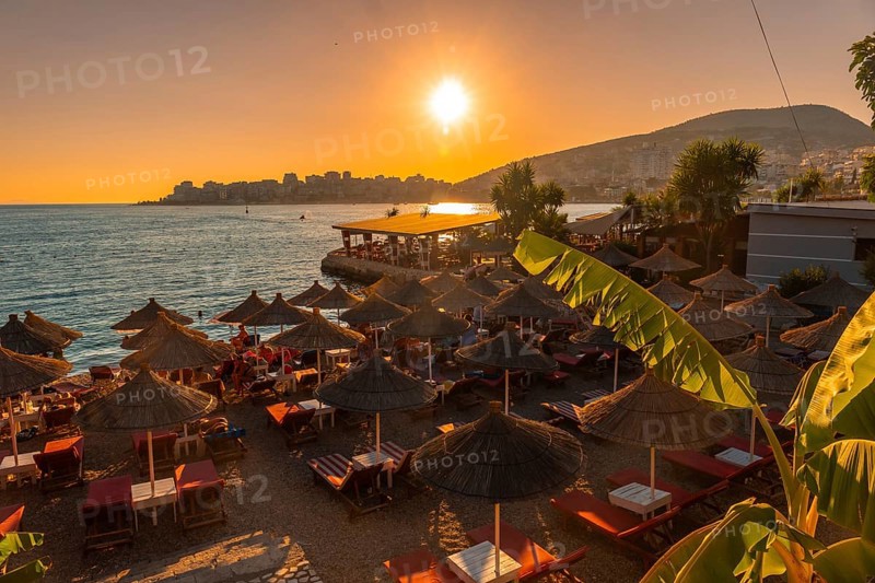Beautiful resort with umbrellas by the sea at sunset in Sarande or Saranda on the Albanian riviera, Albania