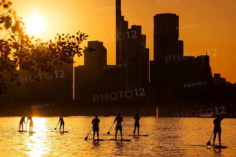 The sun sets behind the Frankfurt banking skyline, Frankfurt am Main, Hesse, Germany