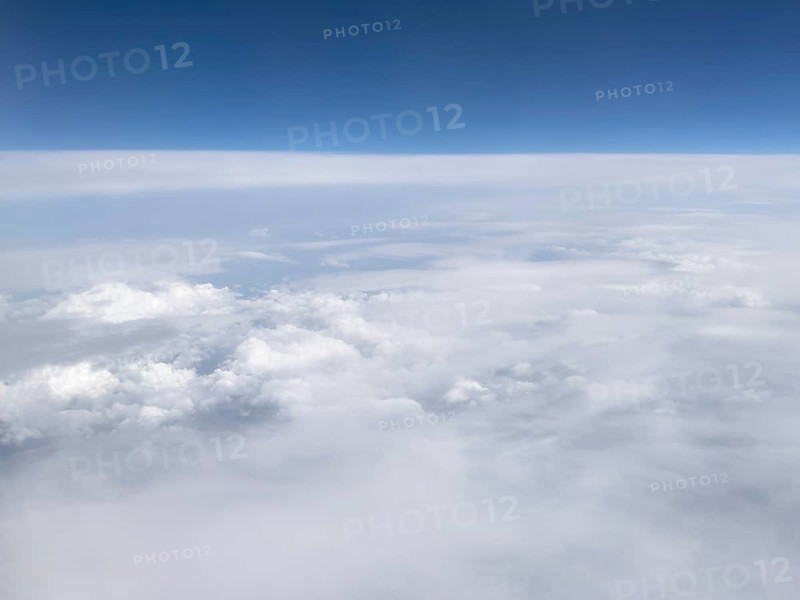 View from aeroplane at high altitude on almost closed cloud cover of white clouds Altostratus and Altocumulus, international