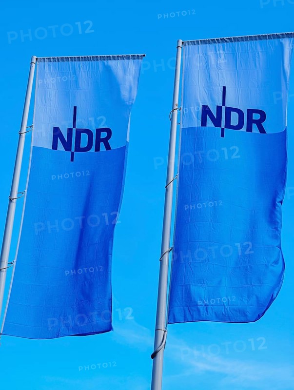 Two flags with lettering NDR, Norddeutscher Rundfunk, flagpoles, colours blue white, light wind, background blue, old town, Kiel, Schleswig-Holstein, Germany