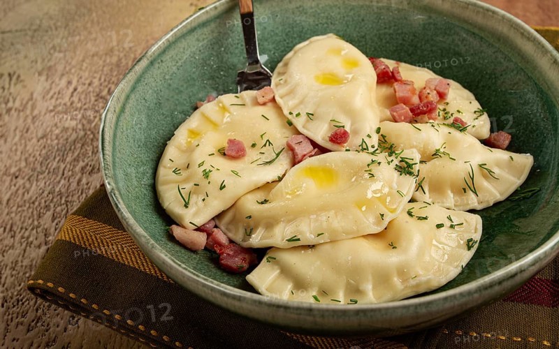 Dumplings, with fried prosciutto, a traditional dish of Polish cuisine, dumplings, top view, close-up, without people