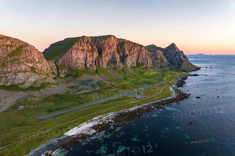 Coast and mountains in the evening light, runway of the abandoned airport, Værøy island, Vaeroy, Lofoten, Norway