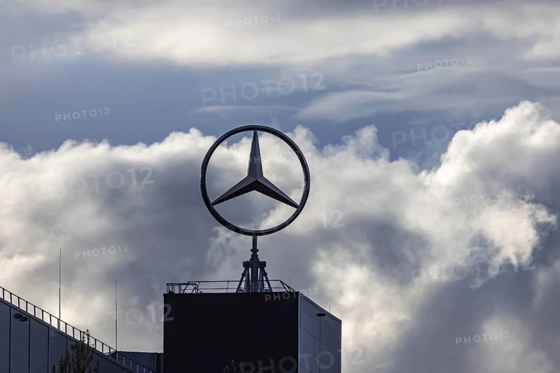 Merecedes Sindelfingen. Factory building with rotating Mercedes star. Backlight with dramatic clouds. Sindelfingen, Baden-Württemberg, Germany