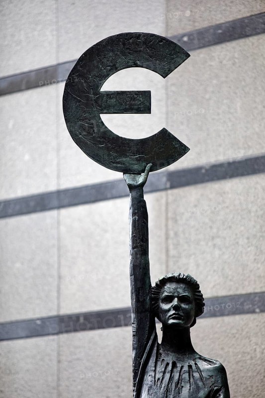 The bronze statue entitled Europe by May Claerhout holds up the euro symbol, Rue Wiertz, European Parliament, Brussels