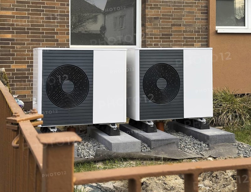 2 heat pumps are installed on an apartment block in a front garden, Hilden, Germany