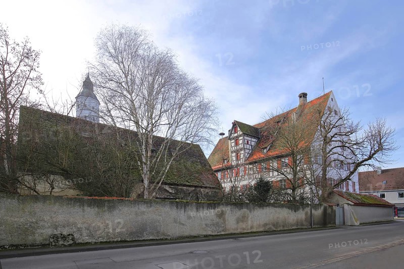 Historic office building built in 1610 with the tower of St Martin's Church, Langenau, Alb-Donau district, Swabian Alb, Baden-Württemberg, Germany