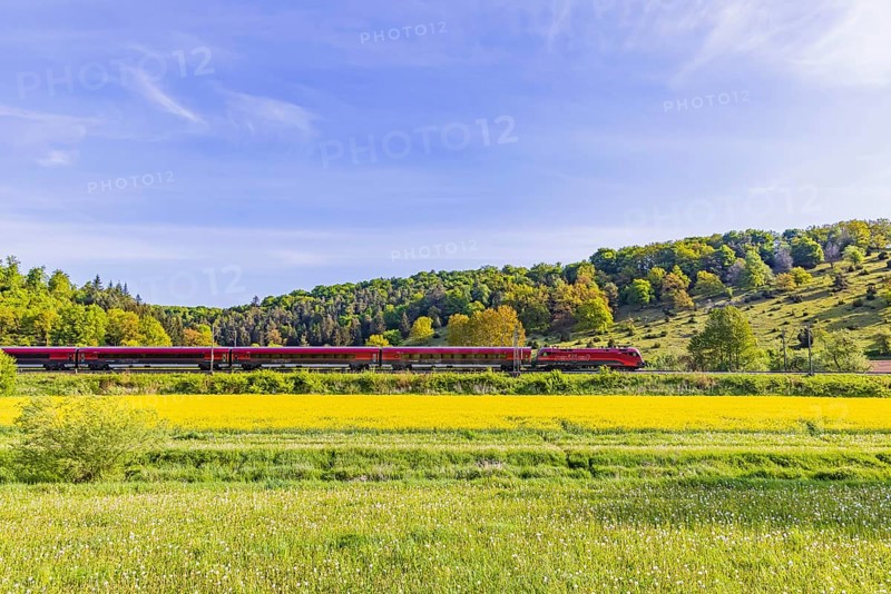 ÖBB RailJet travelling across the Swabian Alb. Idyllic landscape near Lonsee in spring. Lonsee, Baden-Württemberg, Germany
