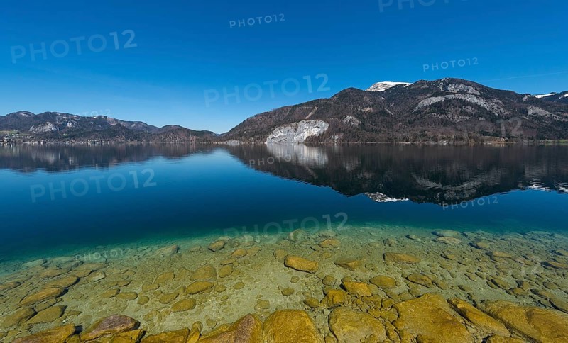 Lake Wolfgang with a reflection of the surrounding mountains, near St. Gilgen, Salzkammergut, Salzburg State, Austria