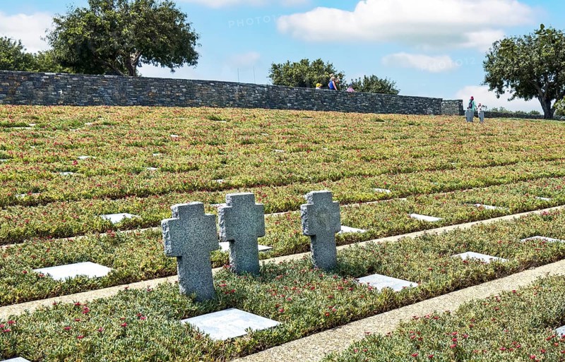 Three stone crosses between rows of grave slabs Gravestones Graves German soldiers' graves on part of German War Graves Commission inaugurated in 1974 by Volksbund Deutsche Kriegsgräberfürsorge German military cemetery on former battlefield in World War II heavily contested hill Height 107, Maleme, Crete, Greece