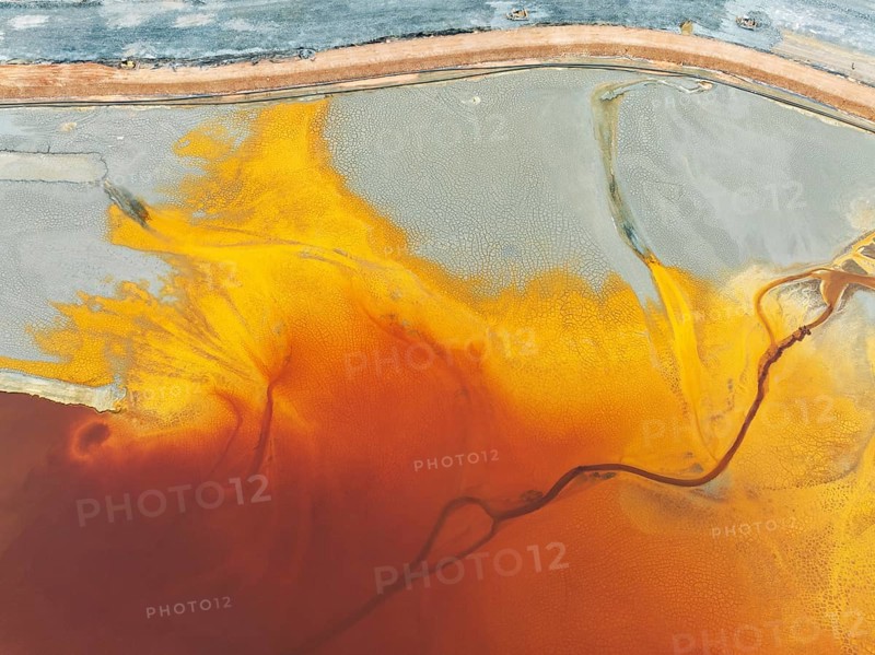 Waste pond in the mineral-rich area of the Rio Tinto mines. The colour is caused by oxidised iron minerals. Aerial view. Drone shot. Huelva province, Andalusia, Spain