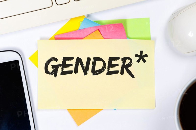 Gendering with gender stars as a symbol for gender-appropriate language Communication concept on desk in