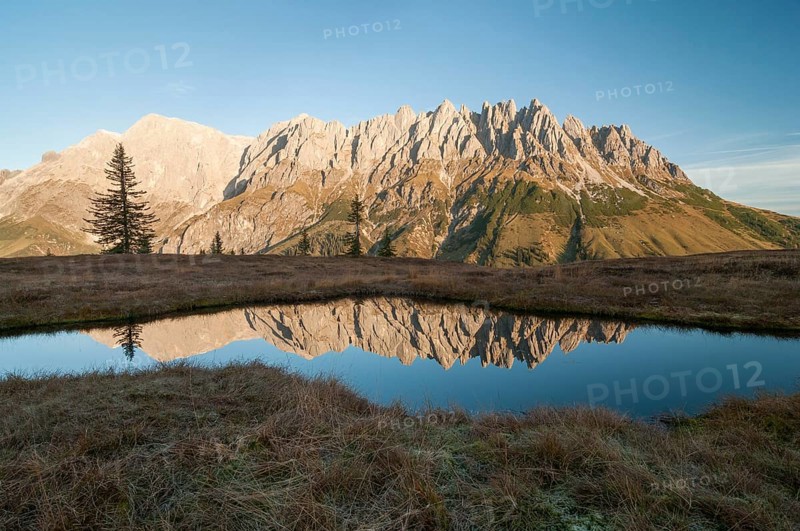 Mandlwände and left Hochkönig in morning light against lake with reflection, Salzburg, Austria