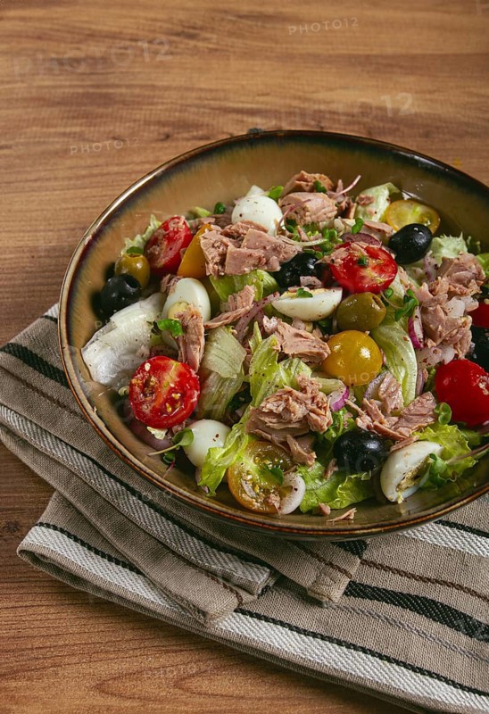 Salad with canned tuna, vegetable salad with quail eggs, lettuce, red onion, cherry tomatoes, olives, keto food, healthy food, homemade, no people