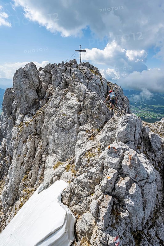 Mountain peak Ackerlspitze with summit cross, mountaineer on the last ascent to the summit, Wilder Kaiser, Kaiser Mountains, Tyrol, Austria