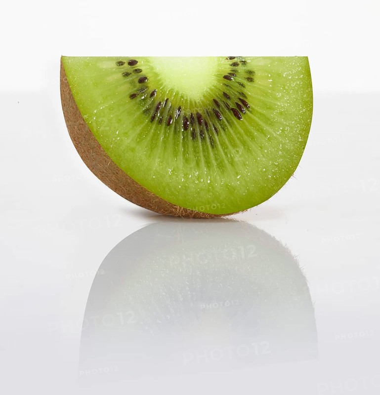 A kiwi slice, kiwi, kiwi fruit, Chinese gooseberry (Actinidia deliciosa) in front of a white background, studio photo