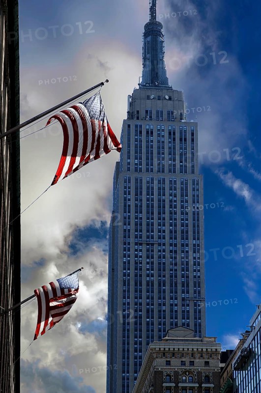 Waving US flag with Empire State Building, New York City, USA