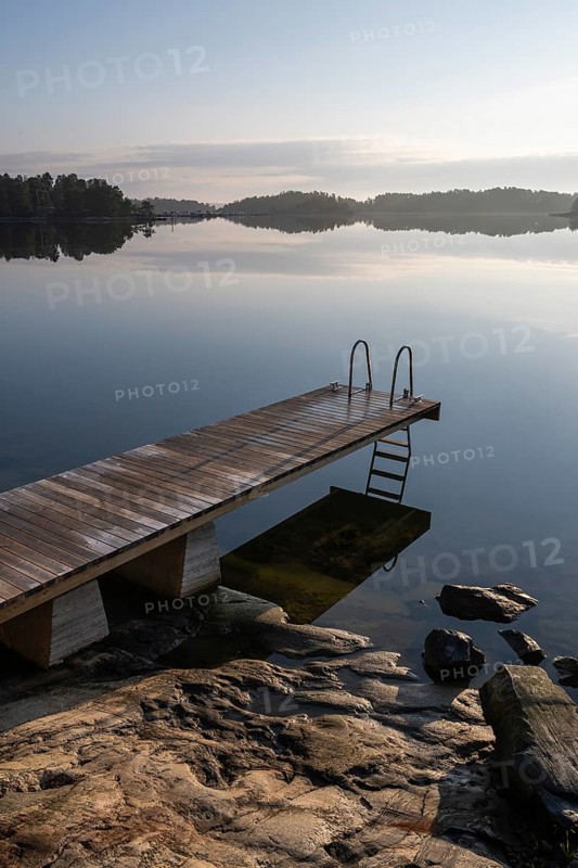 Wooden jetty with ladder, calm water surface, morning atmosphere, Kasnäsintie, Falkö Fjord, Kasnäs, Hitis archipelago, archipelago south of Turku, Finland