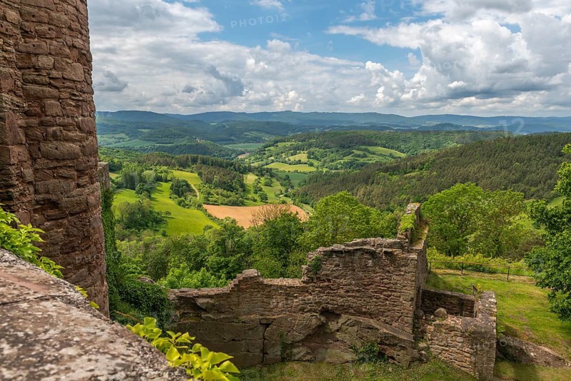 View from the medieval castle ruin Hanstein to the youth castle Ludwigstein and the wooded low mountain range landscape, ruin on red sandstone rocks, fields, Bornhagen, district Eichsfeld, Thuringia, Germany